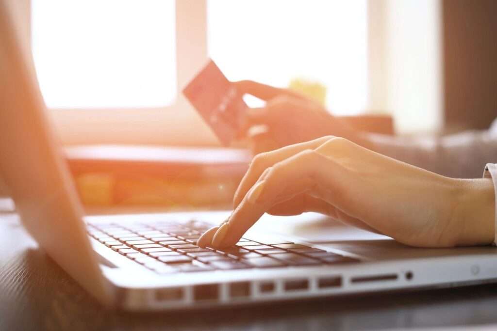 Alt text: LLC paperwork and laptop symbolizing the first step in starting a real estate business