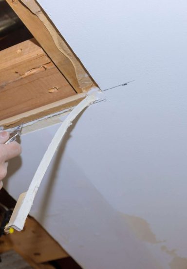 Renovation home improvement apartment interior damage for drywall board with repair home of man cutting plasterboard